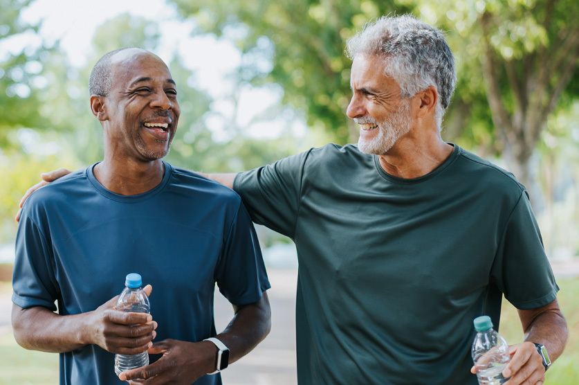 older male friends talking and walking